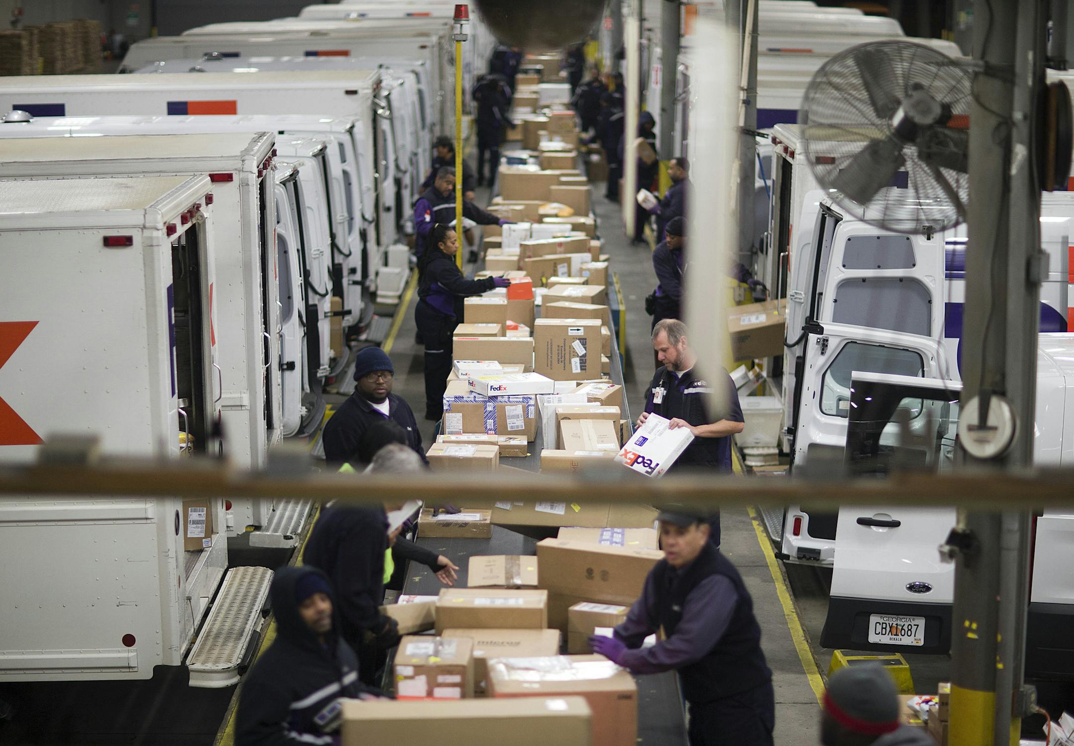 FILE - In this Dec. 14, 2014 file photo, packages are sorted on a conveyer belt before being loaded onto trucks for delivery at a FedEx facility in Marietta, Ga. FedEx on Monday, Oct. 26, 2015 predicted that shipments from Black Friday through Christmas Eve will rise 12.4 percent over last year to 317 million pieces.