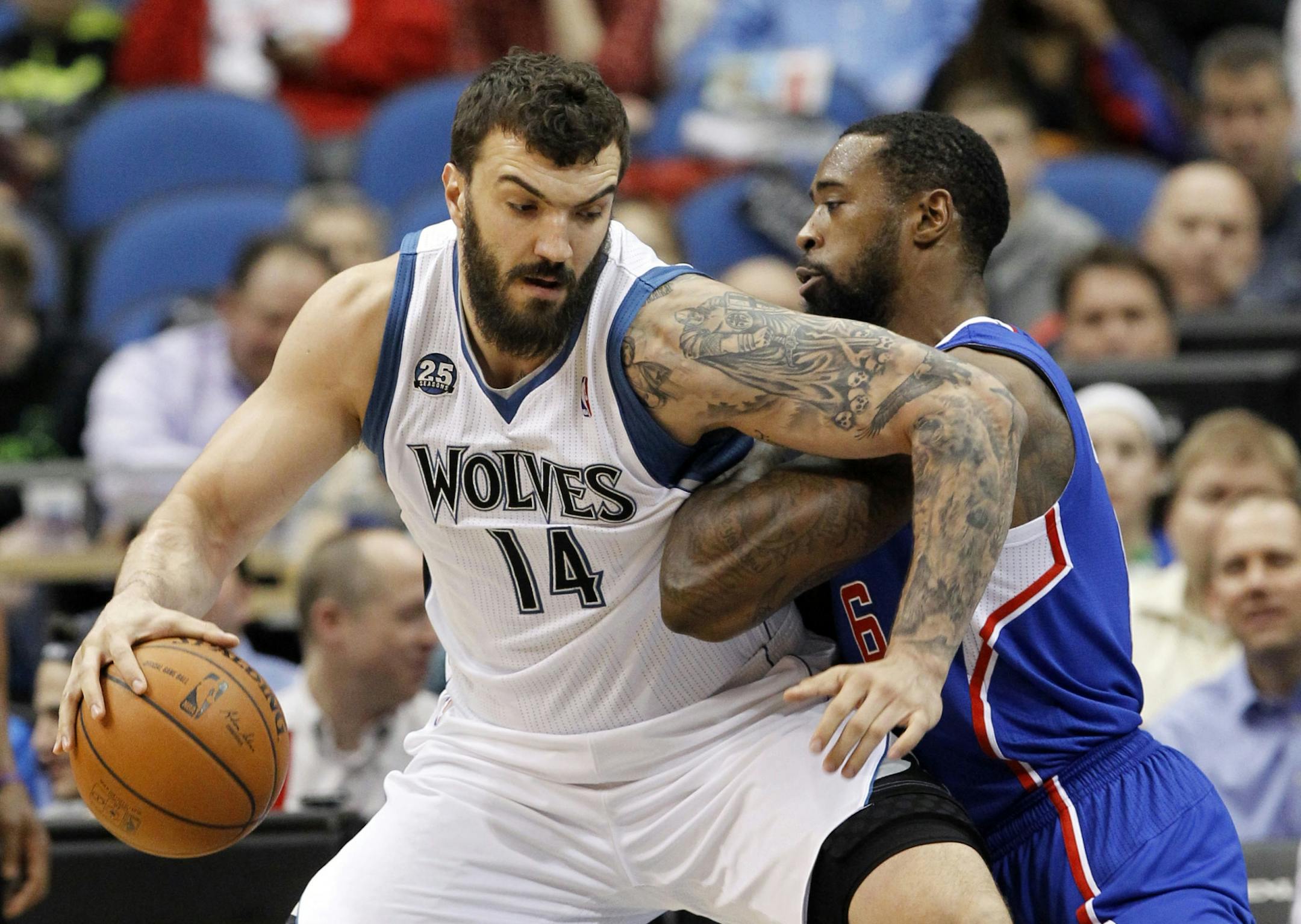 Minnesota Timberwolves center Nikola Pekovic (14), of Montenegro, drives against Los Angeles Clippers center DeAndre Jordan (6) during the first quarter of an NBA basketball game in Minneapolis, Monday, March 31, 2014.