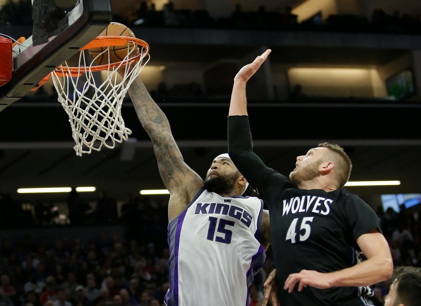 Sacramento Kings center DeMarcus Cousins, left, goes up for a dunk against Minnesota Timberwolves center Cole Aldrich during the second half of an NBA basketball game in Sacramento, Calif., Saturday, Oct. 29, 2016. The Kings won 106-103. (AP Photo/Rich Pedroncelli)