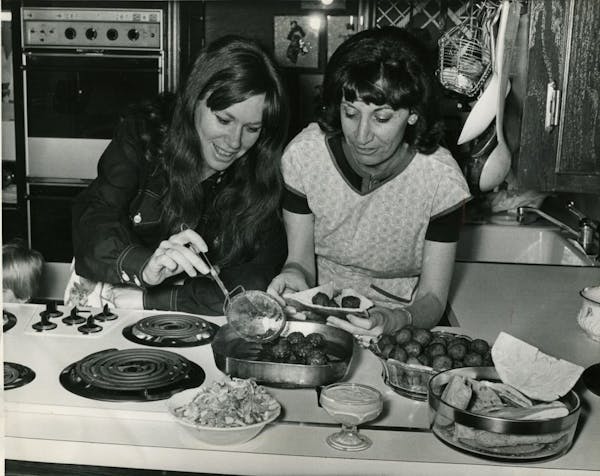 Mrs. Abraham Degani, left, and Mrs. Benjamin Lowenberg make falafel, a vegetable croquette. 1971 Star Tribune file photo. For Taste 40.