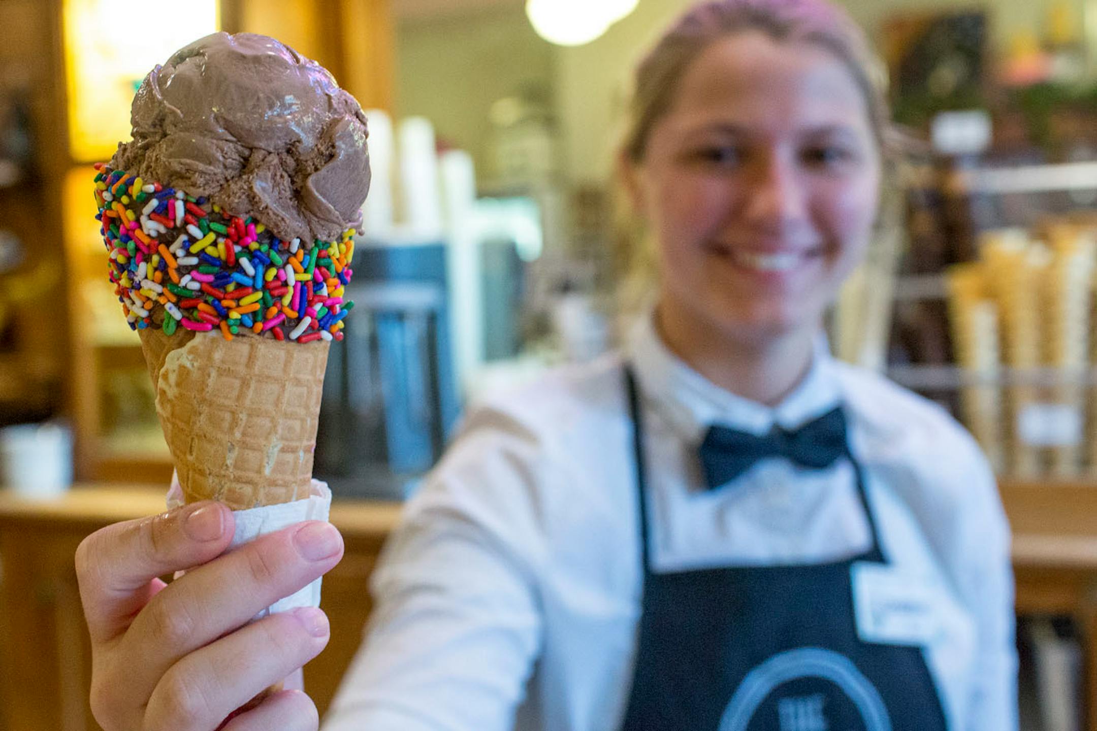 Shannon McCauley holds up a chocolate ice cream cone at the Pearl Ice Cream Parlor. ] COURTNEY PEDROZA • courtney.pedroza@startribune.com June 22-24, 2017; Wisconsin restaurants, cafes, bars, bakeries and breweries; Dining along the Mississippi River.