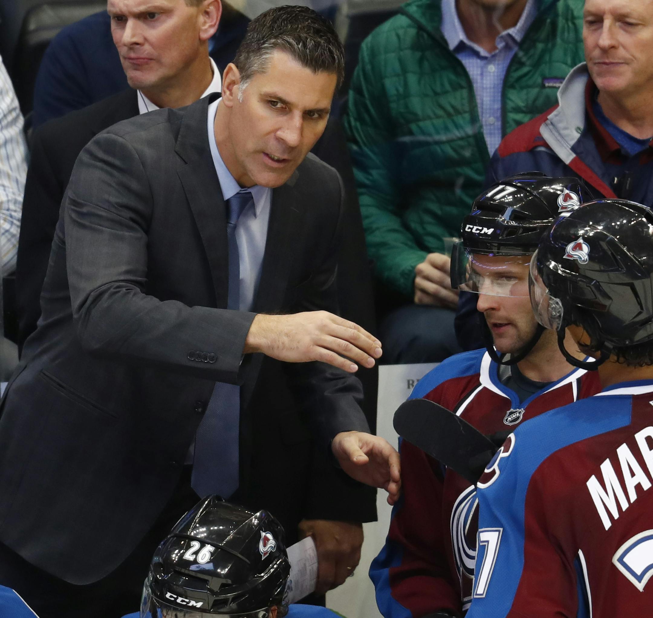 Colorado Avalanche head coach Jared Bednar, left, directs right wing Mike Sislo, center, and left wing Andreas Martinsen as they come off the ice from facing the Minnesota Wild in the second period of an NHL preseason hockey game, Tuesday, Oct. 4, 2016, in Denver. (AP Photo/David Zalubowski) ORG XMIT: CODZ107