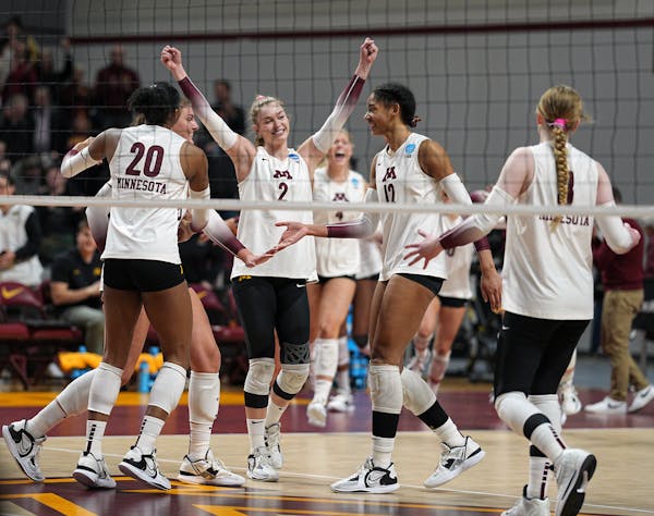 University of Minnesota's Jenna Wenaas (2) celebrates with Taylor Landfair (12) and fellow teammates after a 3-0 victory over UNI  to advance to the s