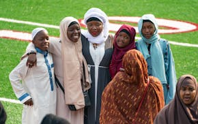 People posed for photos after the first Eid Al-Adha prayer service in Huntington Bank Stadium at the University of Minnesota.