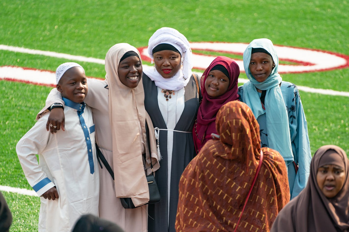 People posed for photos after the first Eid Al-Adha prayer service in Huntington Bank Stadium at the University of Minnesota.