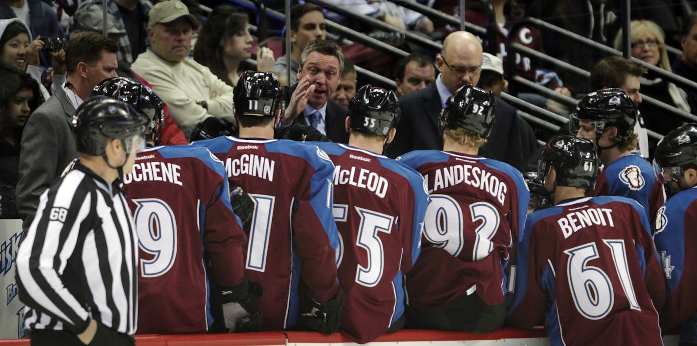 Colorado Avalanche coach Patrick Roy, center, talks to his team durin a timeout in the first period of an NHL hockey game against the St. Louis Blues in Denver, Wednesday, Nov. 27, 2013. (AP Photo/Joe Mahoney)