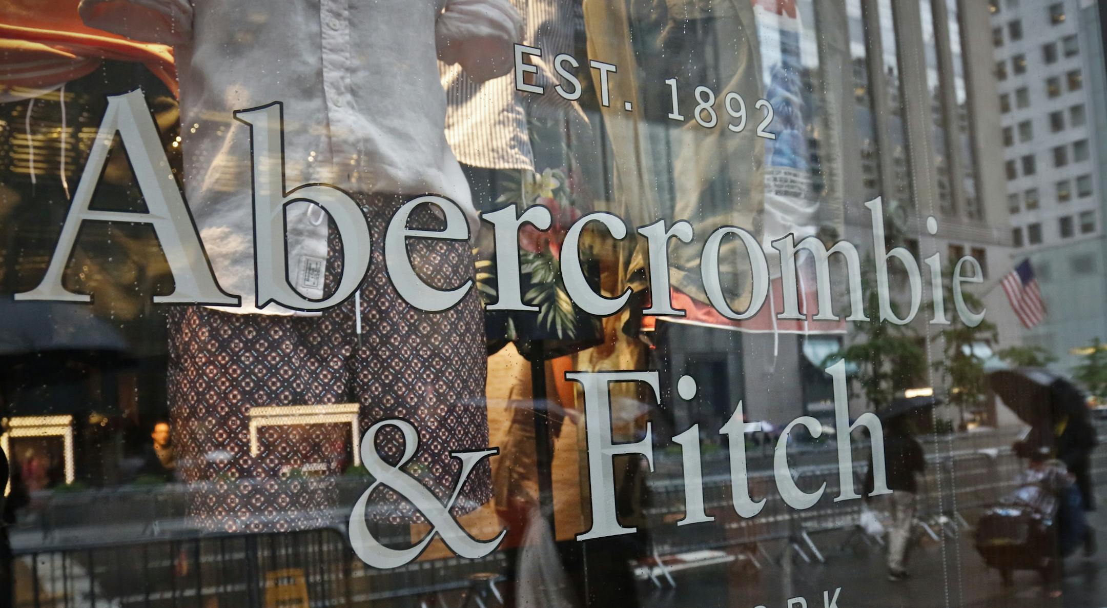 FILE - In this Monday, May 22, 2017, file photo, a store window reflects a street scene at an Abercrombie & Fitch store on New York's Fifth Avenue. On Monday, July 10, 2017, teen retailer Abercrombie & Fitch is no longer looking to sell itself, announcing that it will stick with its current strategy. (AP Photo/Bebeto Matthews, File)