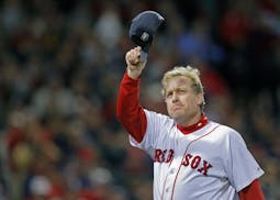 Boston Red Sox pitcher Curt Schilling tips his hat to the crowd as he leaves the mound for what would be the last time in the sixth inning against the