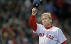 Boston Red Sox pitcher Curt Schilling tips his hat to the crowd as he leaves the mound for what would be the last time in the sixth inning against the