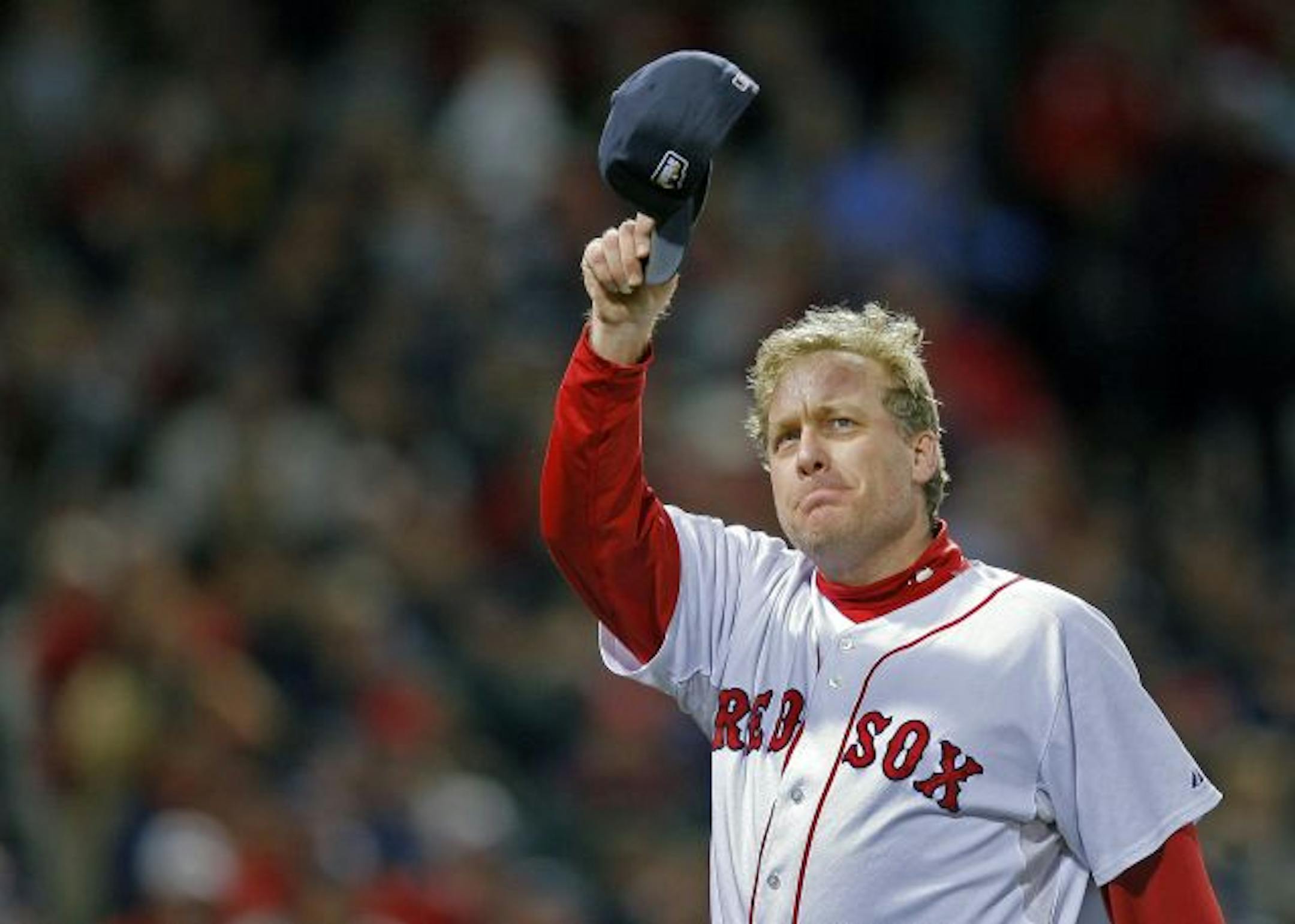 Boston Red Sox pitcher Curt Schilling tips his hat to the crowd as he leaves the mound for what would be the last time in the sixth inning against the Colorado Rockies during game two of the 2007 World Series at Fenway Park in Boston, Oct. 25, 2007.