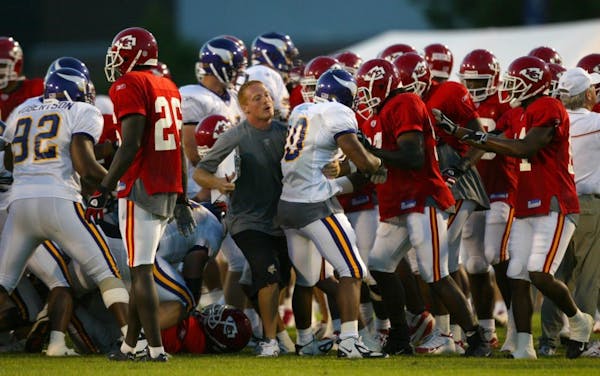 Hard hits, including some by pro wrestler Brock Lesnar during a 2004 tryout with the Vikings, led to scenes like this one during a joint scrimmage wit