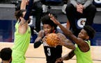 Houston Rockets guard Kevin Porter Jr. (3) drives on Minnesota Timberwolves forward Anthony Edwards, right and guard Ricky Rubio during the first quar