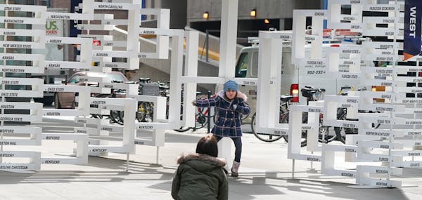 Adrianna Teicher, 6, struck a pose Monday morning in front of the Final Four bracket on Nicollet Mall.