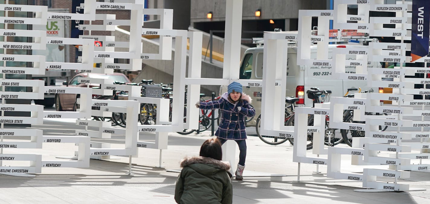 Adrianna Teicher, 6, struck a pose Monday morning in front of the Final Four bracket on Nicollet Mall.