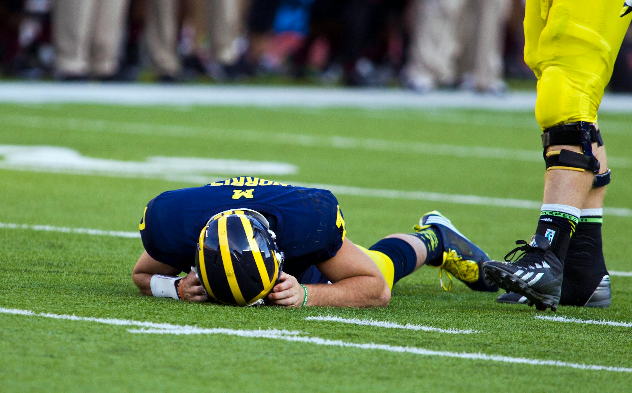 Michigan quarterback Shane Morris lays on the field after taking a hit in the fourth quarter of an NCAA college football game against Minnesota in Ann Arbor, Mich., on Sept. 27.