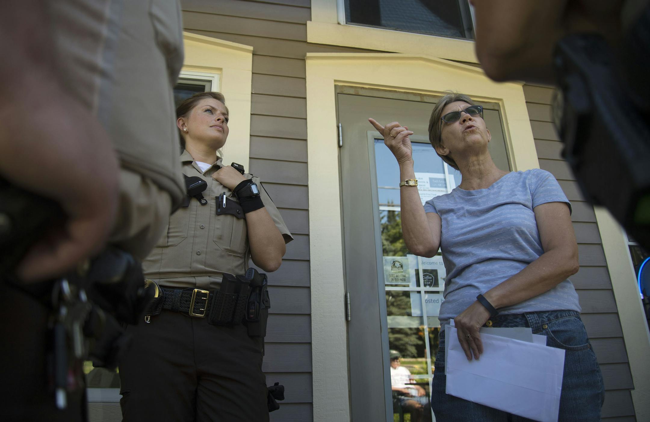 Center from left, Deputy Sheriff Amber Hoheisel looked away while Julie Stenberg Zeidel, of Afton, talked about noise levels to other Deputy Sherrifs as part of the Coffee With a Cop program in Afton, Minn., on Thursday July 23, 2015. The program intends for cops to meet and connect with law-abiding citizens of Washington County. ] RACHEL WOOLF · rachel.woolf@startribune.com