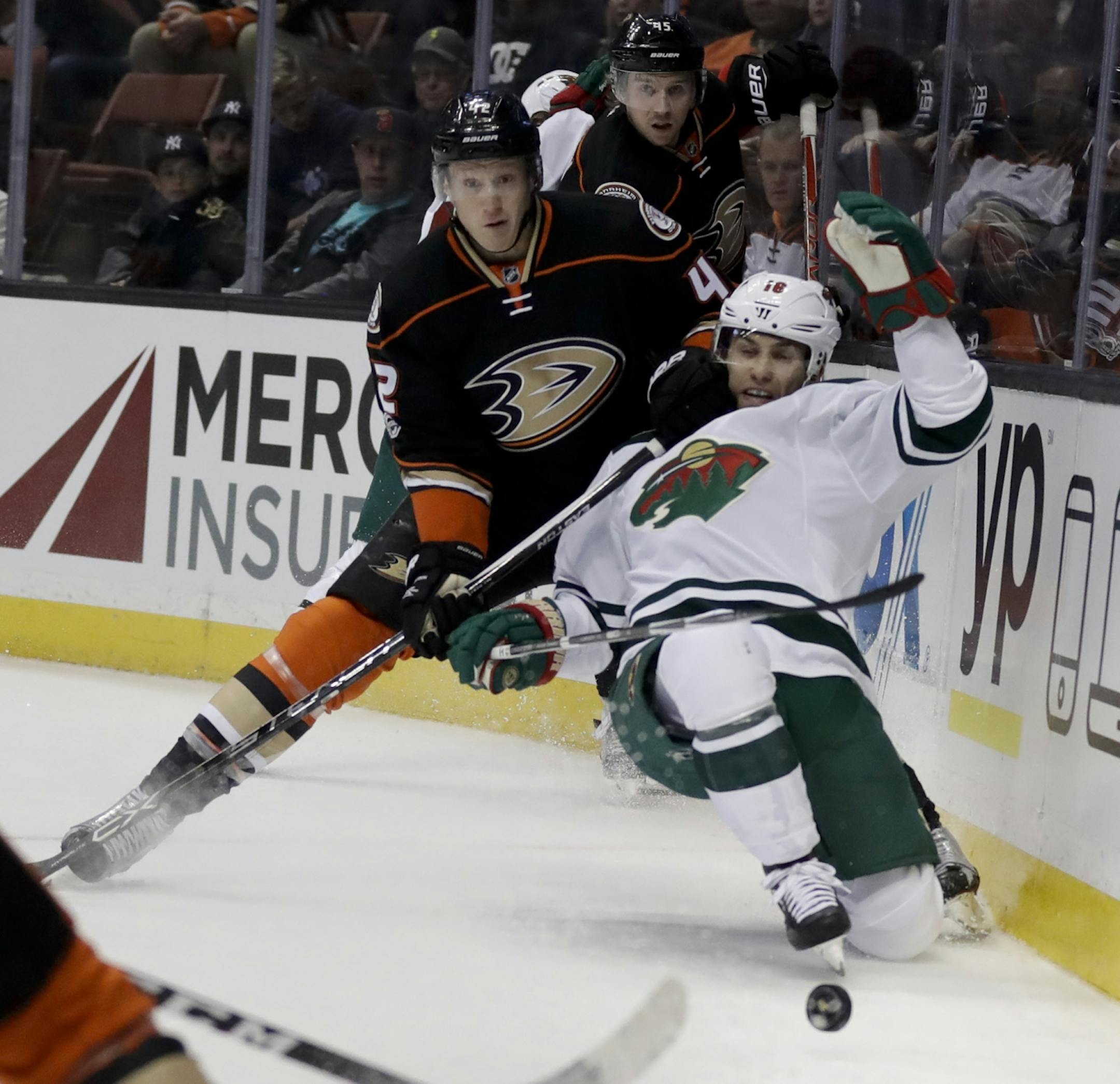 Anaheim Ducks defenseman Josh Manson holds Minnesota Wild left wing Jason Zucker during the first period of an NHL hockey game in Anaheim, Calif., Sunday, Jan. 8, 2017.