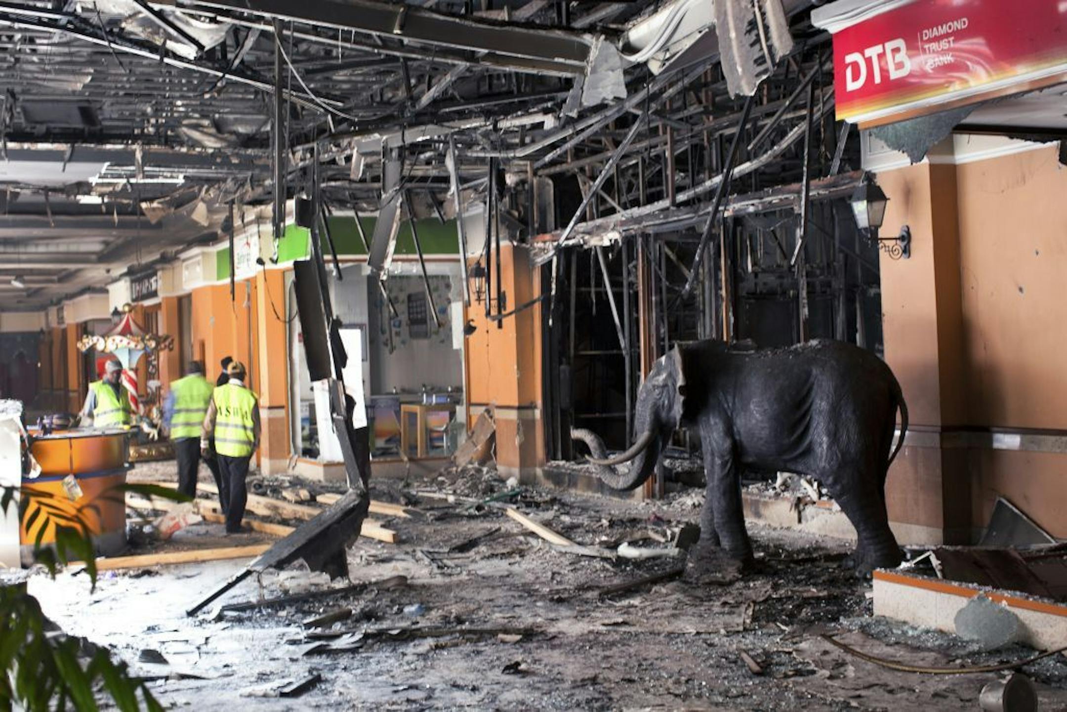 Workers examine debris left from damage caused during a four-day siege at Westgate Mall in Nairobi, Kenya, Sept. 30, 2013.