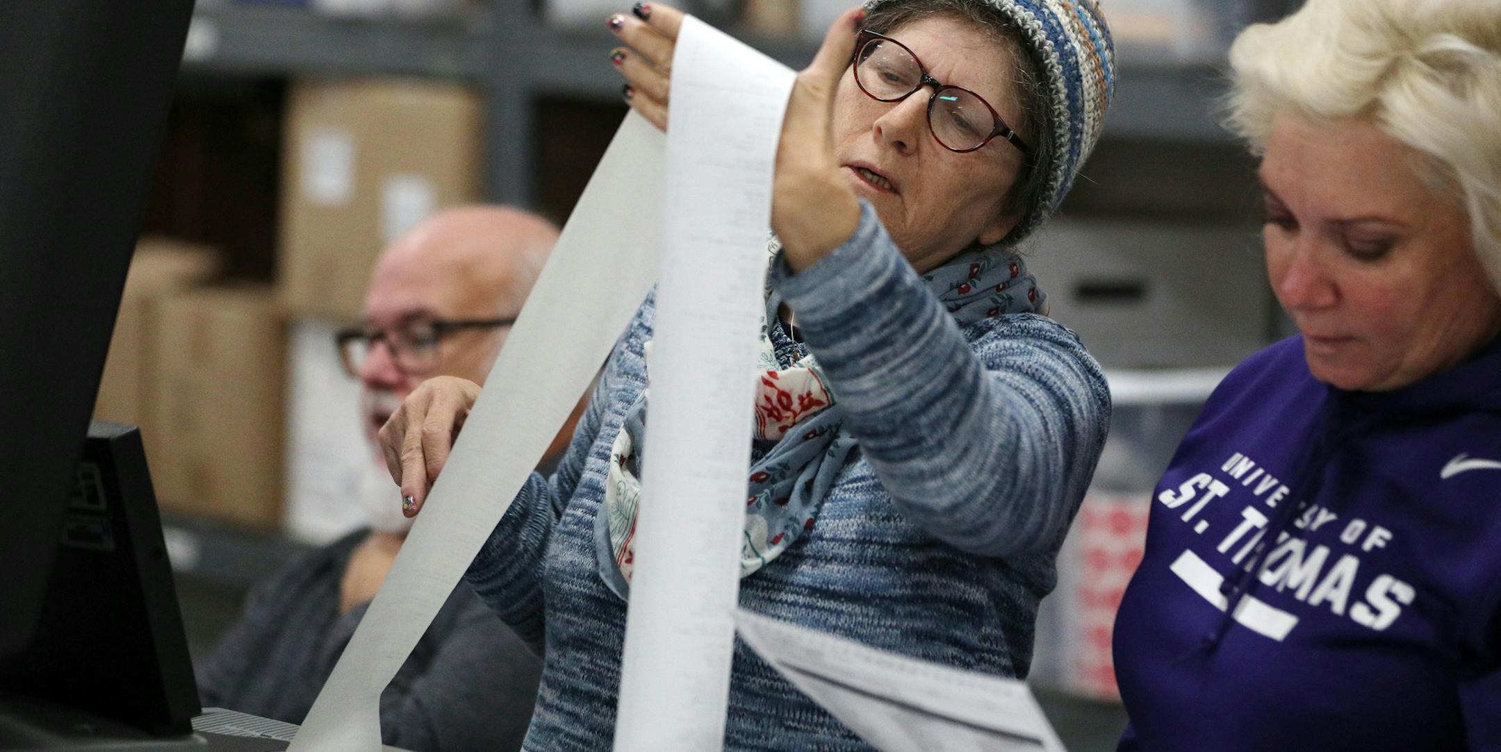 Jane Strauss, left, and Tracy Armstrong looked through a voter printout as they helped test Minneapolis' electronic voting system Tuesday. ] ANTHONY SOUFFLE • anthony.souffle@startribune.com Minneapolis city staff tested a randomly selected assortment of voting machines to demonstrate the accuracy of the computer program, voting equipment and ballots Tuesday, Oct. 31, 2017 at an equipment storage center in Northeast Minneapolis.