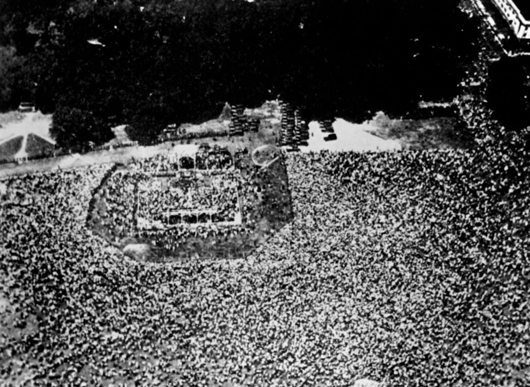 A massive crowd welcomed Charles Lindbergh on the grounds of the Washington Monument after his return from Paris and Europe.