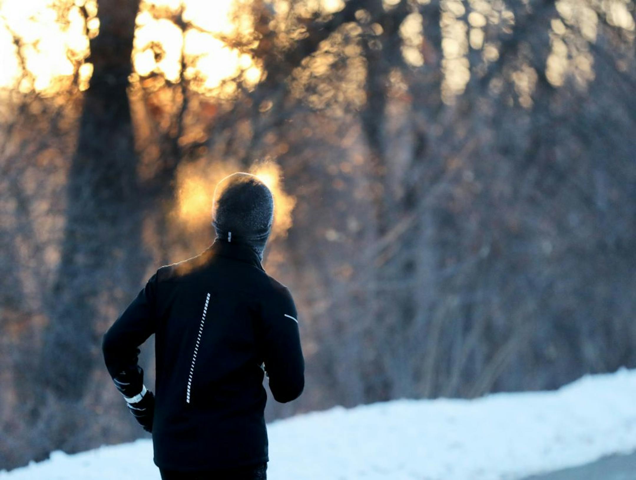 A runner endures frigid temps while running along West River Parkway, with temps hovering near minus 30 degrees with wind chills Thursday, Feb. 13, 2020, near downtown Minneapolis, MN.