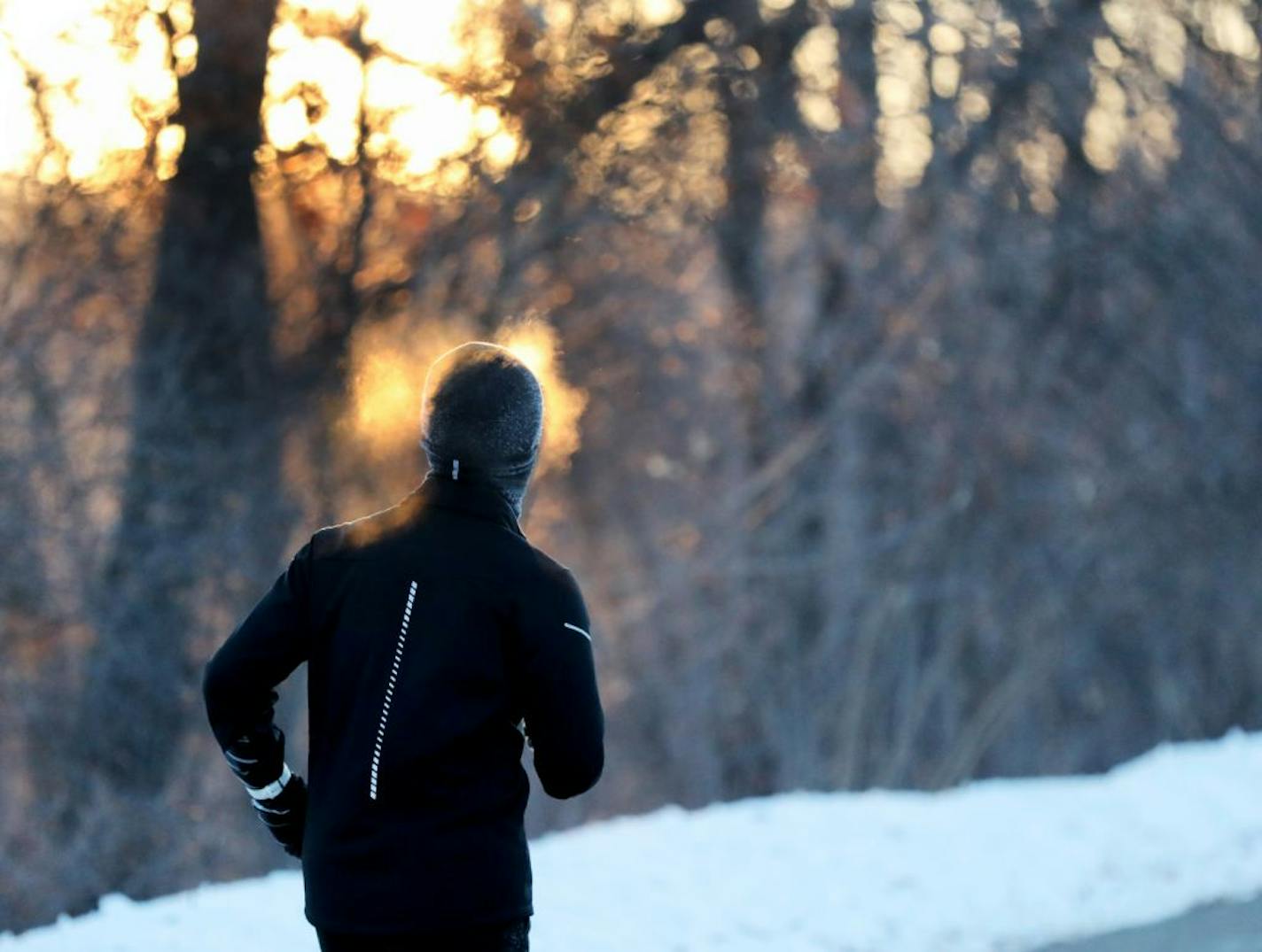 A runner endures frigid temps while running along West River Parkway, with temps hovering near minus 30 degrees with wind chills Thursday, Feb. 13, 2020, near downtown Minneapolis, MN.