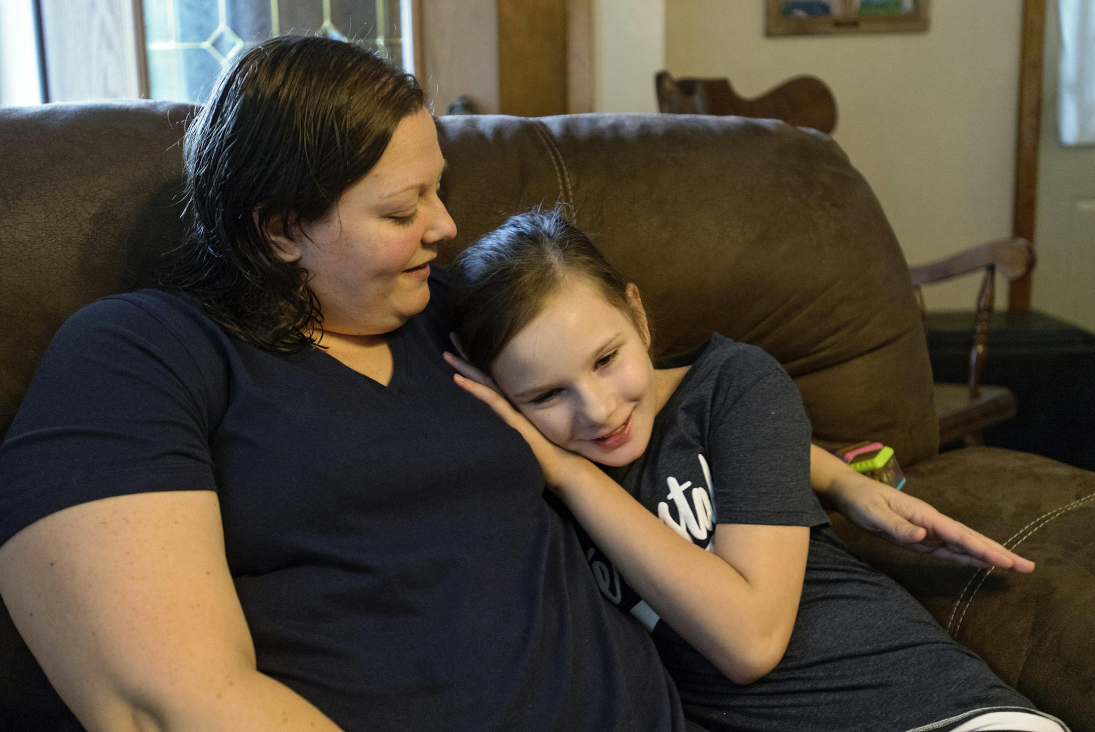 Leah Williams ,11, snuggles into her mom Krista on Wednesday, Sept. 7, 2016 in Kylertown, Pa. Leah is one of 9 females in the country with a rare gene mutation that has led to 30 or more gene mutations. (Abby Drey/Centre Daily Times/TNS) ORG XMIT: 1189911
