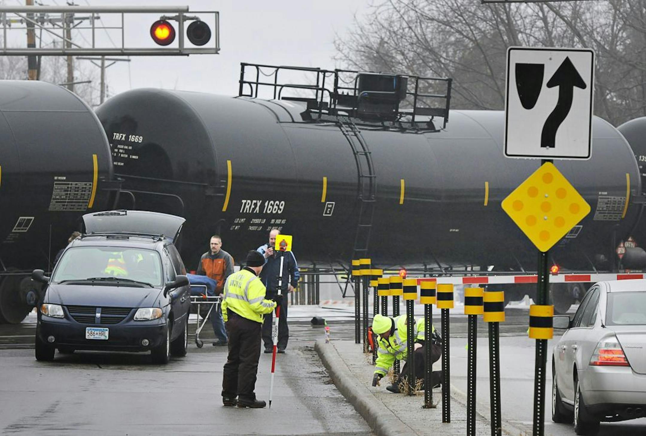 The Minnesota State Patrol investigates the scene after a pedestrian was hit by a train Thursday, March 27, 2014 at the Seventh Street Southeast train crossing near Lincoln Avenue in St. Cloud, Minn. The incident happened about 7 a.m. Thursday.