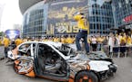 Nashville Predators fan Nick Olp swings a sledge hammer as he takes a turn beating up a car painted with Anaheim Ducks logos before Game 6 of the West