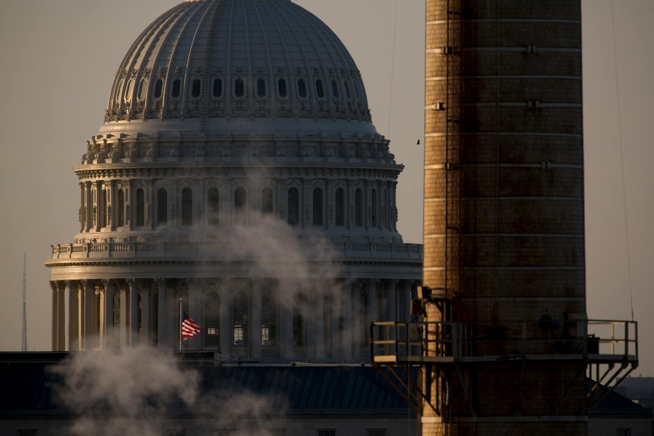 The U.S. Capitol Building stands past the natural gas and coal fueled Capitol Power Plant, which provides heating and cooling throughout the 23 facilities on Capitol Hill including House and Senate Office Buildings, in Washington, D.C., U.S., on Sunday, June 1, 2014. President Barack Obama will propose cutting greenhouse-gas emissions from the nation's power plants by an average of 30 percent from 2005 levels, a key part of his plan to fight climate change that also carries political risks. Phot