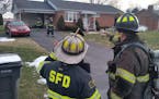 Fire Chief Randy O'Donnell of Shippensburg, Pa., left, discusses the plan for clearing smoke from a house. All-volunteer fire departments like his are
