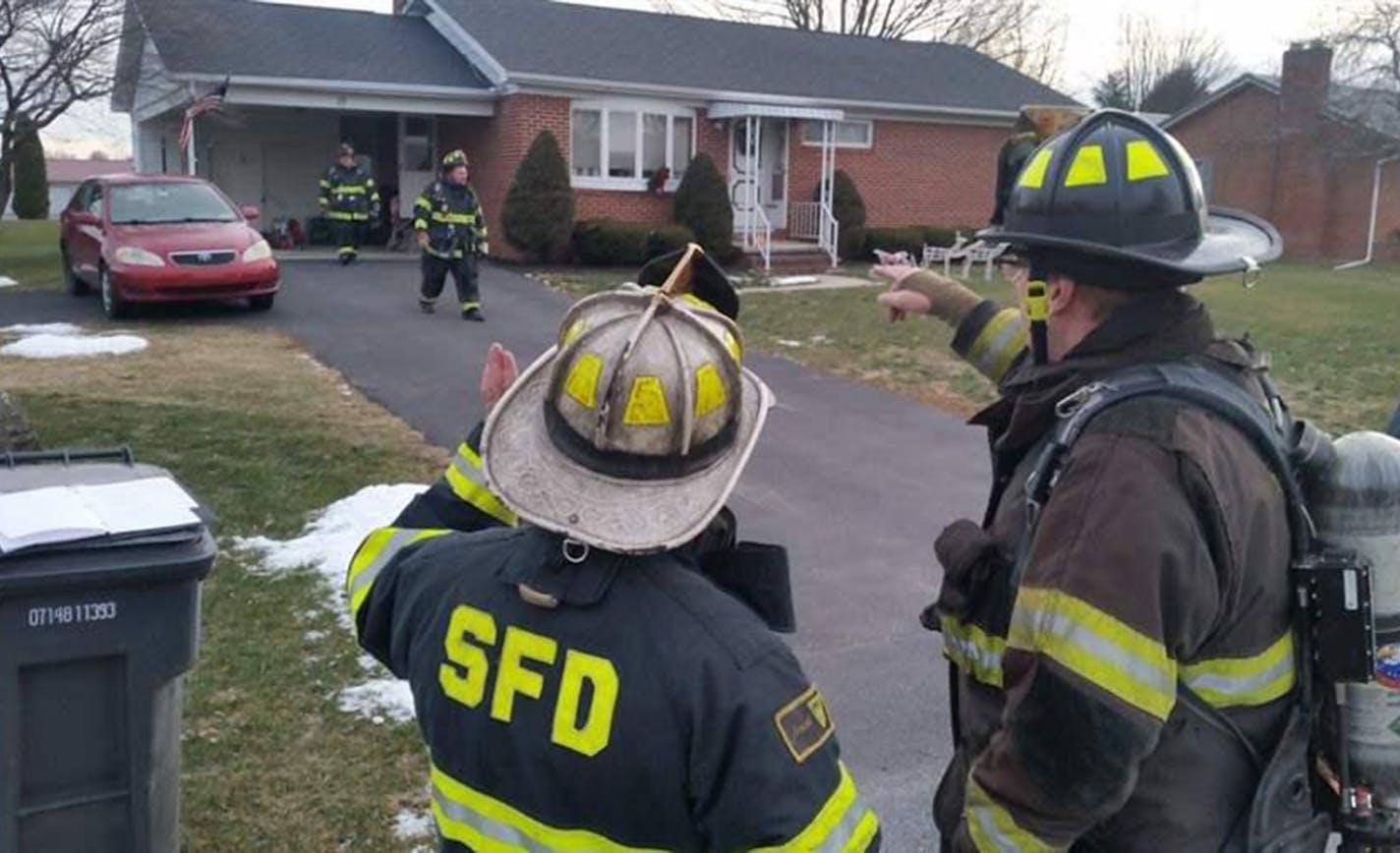 Fire Chief Randy O'Donnell of Shippensburg, Pa., left, discusses the plan for clearing smoke from a house. All-volunteer fire departments like his are finding it harder to recruit new members. (The Pew Charitable Trusts)