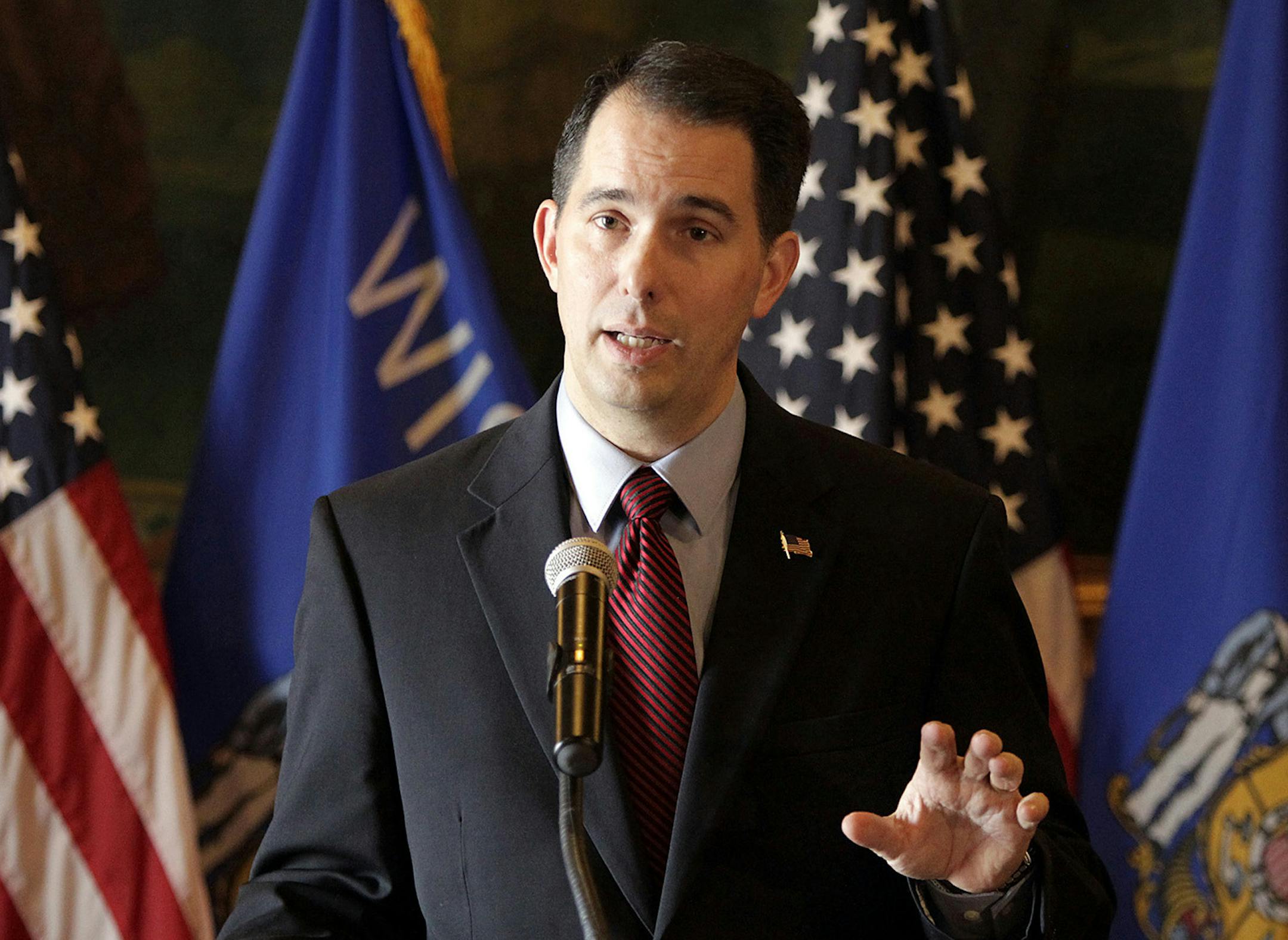 Wisconsin Gov. Scott Walker talks about his call for a special session of the Legislature to delay shifting more than 100,000 Wisconsinites to the federal health insurance exchange, during a press conference at the state Capitol in Madison, Wis., Thursday, Nov. 14, 2013. Walker says he wants to see the deadline moved to April 1. That would give people more time to get insurance through the online exchange created under the federal health overhaul. (AP Photo/Wisconsin State Journal, M.P. King) OR