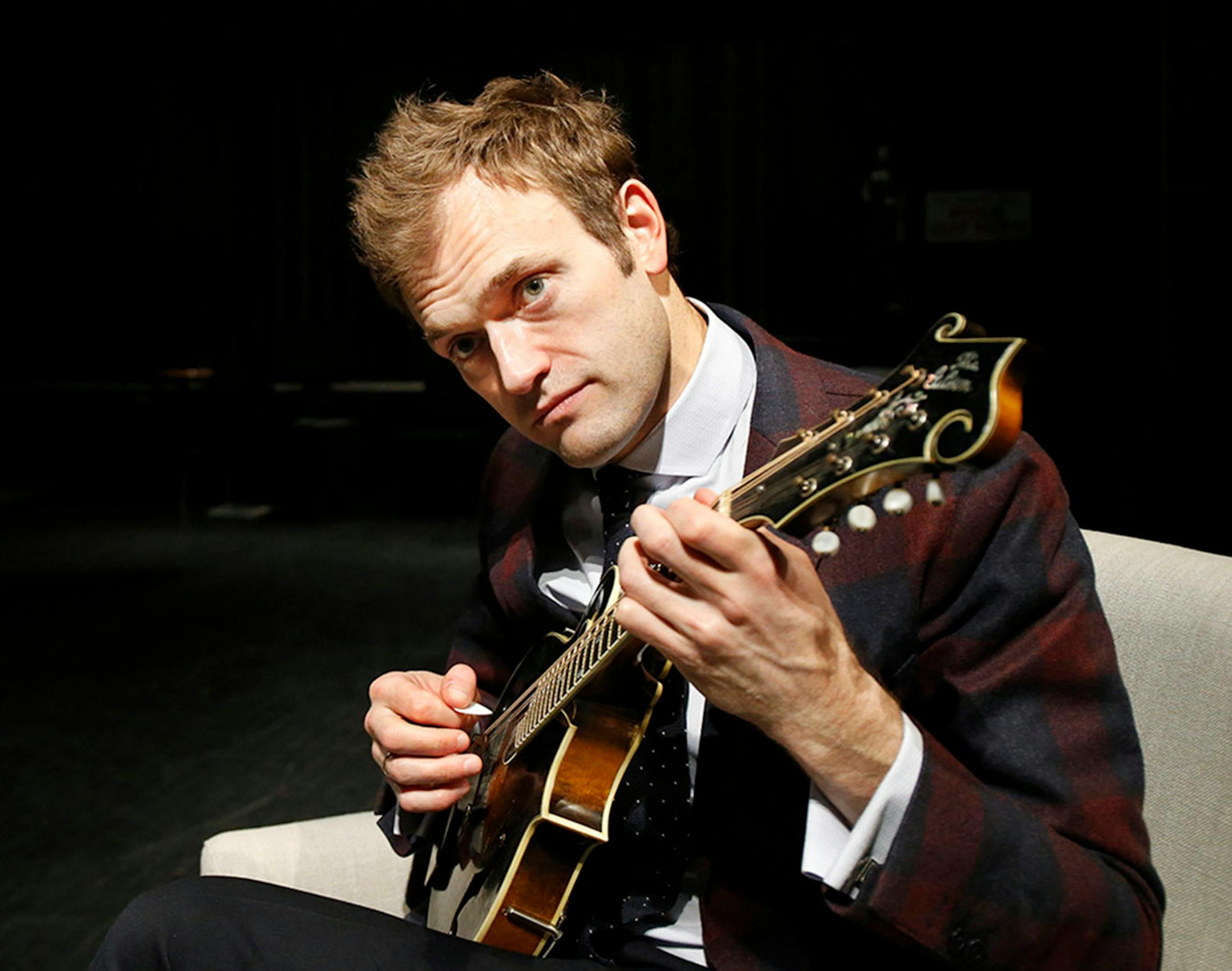 In this April 5, 2016 photo, Chris Thile plays his mandolin on stage at the Fitzgerald Theater in St. Paul, Minn. Thile will replace Garrison Keillor as host of "A Prairie Home Companion," the popular radio variety show, after Keillor retires this summer. Thile starts hosting a 13-episode run of the show in October.