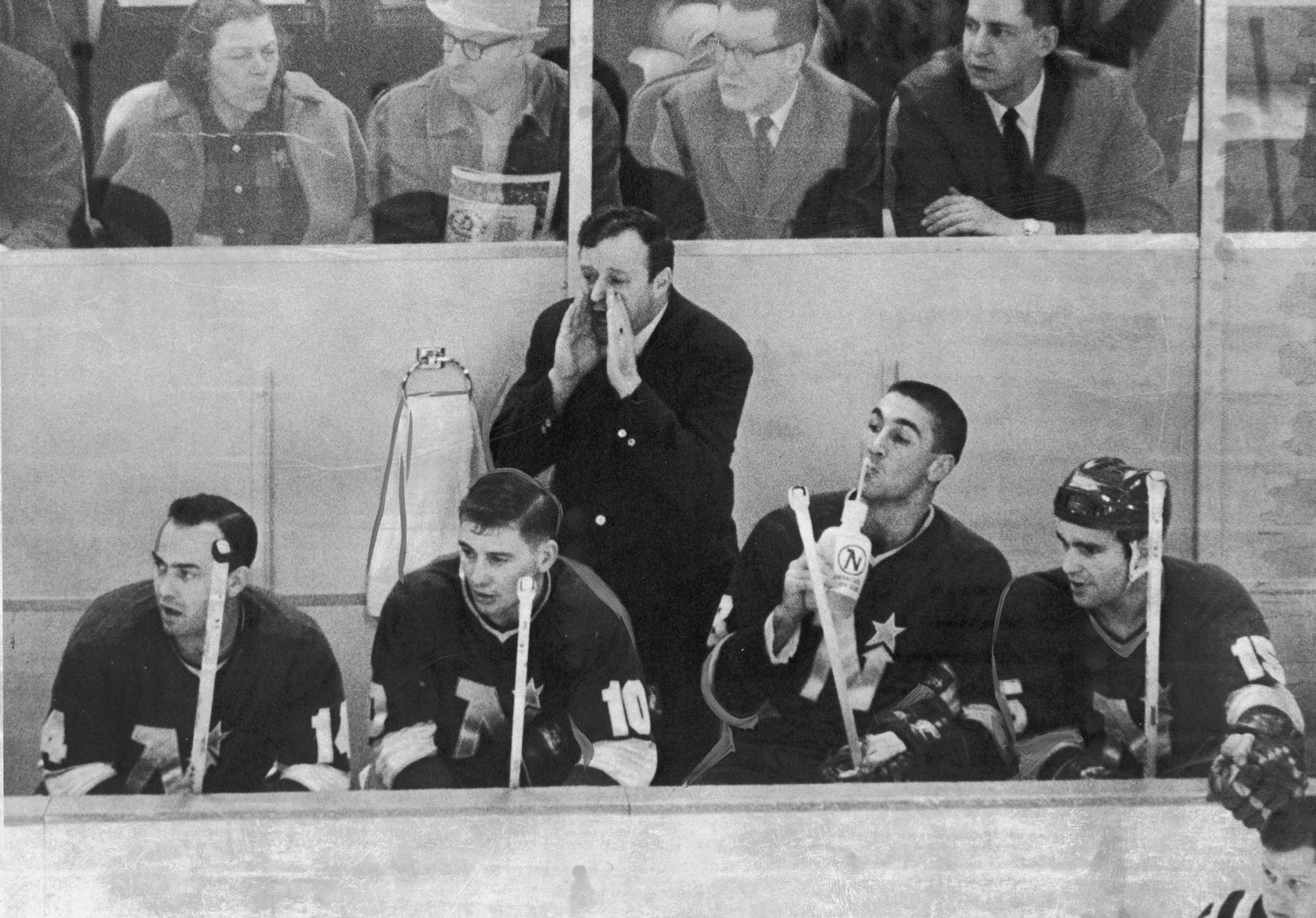 Minnesota North Stars hockey,1968. Rest period for (left to right) MacDonald, Cullen, Collins, Boudrias. Collins drinks water while coach Wren Blair yells instructions. Minneapolis STAR (now Star Tribune) photo March 7, 1968, by Larry Schreiber. ORG XMIT: MIN2013010411564236