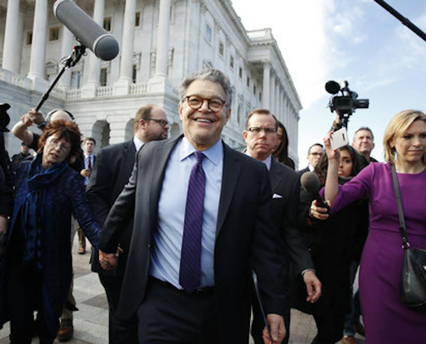 Sen. Al Franken, D-Minn., center, holds hands with his wife Franni Bryson, as he leaves the Capitol after speaking on the Senate floor, Thursday, Dec. 7, 2017, on Capitol Hill in Washington. Franken said he will resign from the Senate in coming weeks following a wave of sexual misconduct allegations and a collapse of support from his Democratic colleagues, a swift political fall for a once-rising Democratic star. (AP Photo/Jacquelyn Martin)