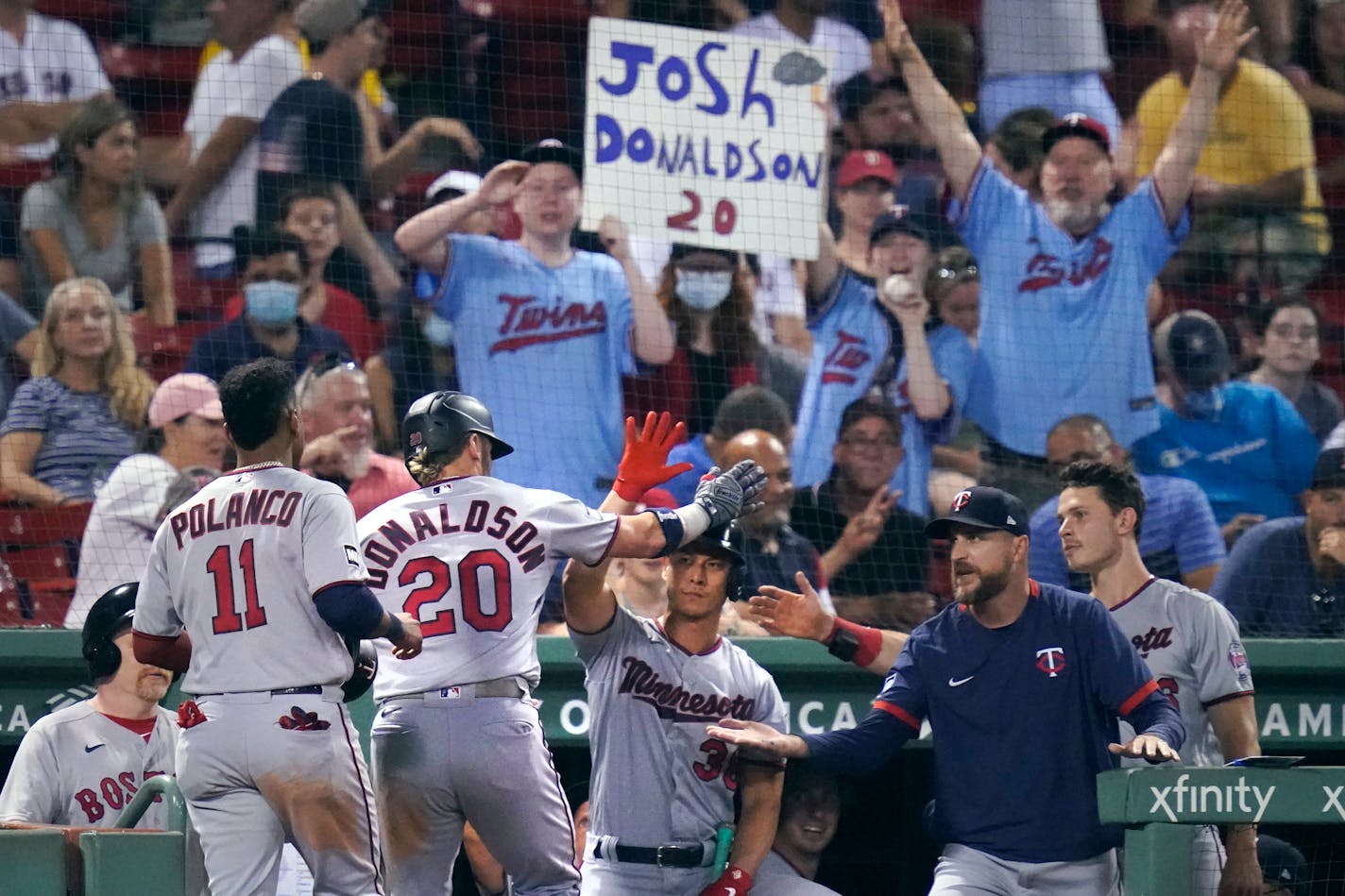 Minnesota Twins' Josh Donaldson (20) is congratulated after his tie-breaking, two-run home run during the 10th inning of a baseball game against the Boston Red Sox at Fenway Park, Wednesday, Aug. 25, 2021, in Boston. (AP Photo/Charles Krupa)