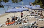 Tourists relax by the sea at Club Med in Grecolimano, Greece.
