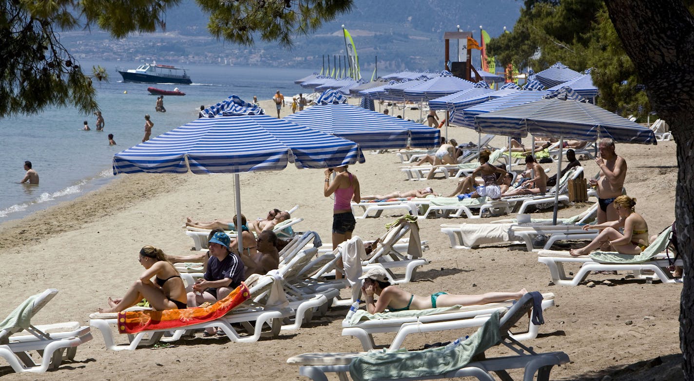 Tourists relax by the sea at Club Med in Grecolimano, Greece.