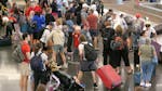Holiday travelers wait for their luggage after arriving at Salt Lake City International Airport Wednesday, July 3, 2024, in Salt Lake City. (AP Photo/