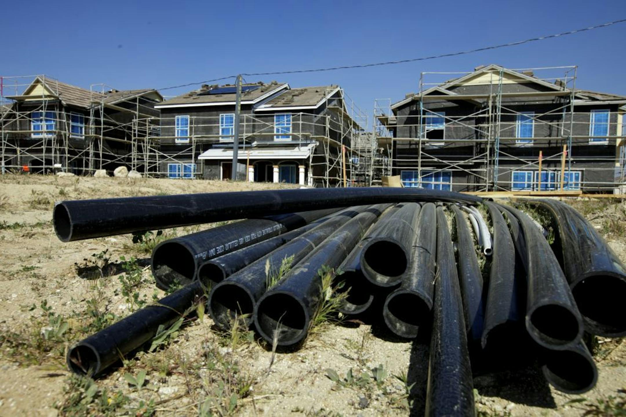 In this photo taken Thursday, March 15, 2012, PVC pipes are seen next to new single-family detached homes being built by Lennar at the "Aria at West Creek" development in Santa Clarita, Calif. U.S. builders started work on slightly fewer homes in February, but they began preparing for what could be the healthiest spring buying season since the housing bubble burst.