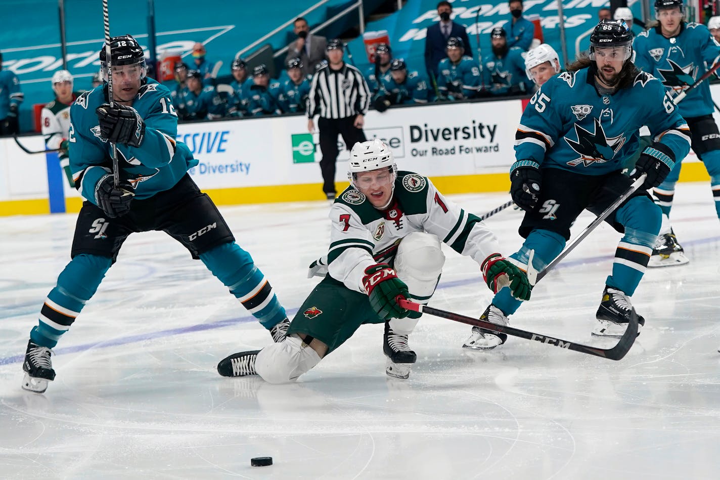 Wild center Nico Sturm skates toward the puck in front of San Jose Sharks center Patrick Marleau (12) and defenseman Erik Karlsson (65) during the second period