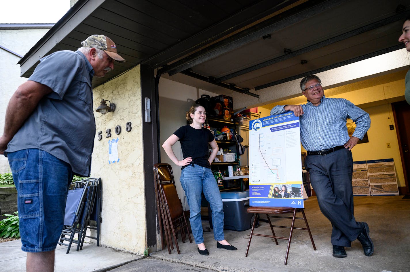 Longtime Robbinsdale resident Sam Good, left, looked at a map of the proposed Blue Line route Wednesday as he stood beside Anna Schmiel, a policy aide the Hennepin County Commissioner, and Dan Soler, with Hennepin County Public Works, during an informational meeting Wednesday night.