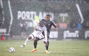 Minnesota United FC's Jermaine Taylor and Vancouver Whitecaps FC's Kekuta Manneh battled for the ball during the first half as the Minnesota United FC