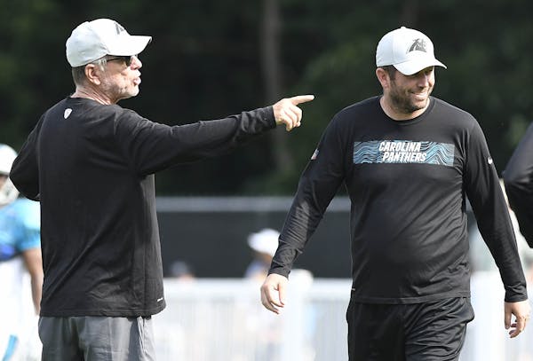 Carolina Panthers offensive coordinator Norv Turner, left, makes a point as quarterbacks coach, and son, Scott Turner looks on, during practice at tra