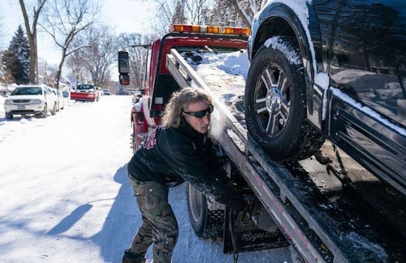 Kerry Brendmoen of Corky's Towing removed a vehicle that was parked on the wrong side of a snow emergency route in south Minneapolis last month.