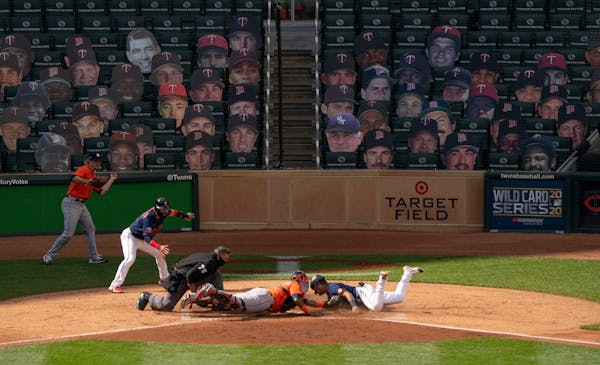 Minnesota Twins second baseman Luis Arraez (2) was tagged out at home by Houston Astros catcher Martin Maldonado (15) in the fifth inning. His would h