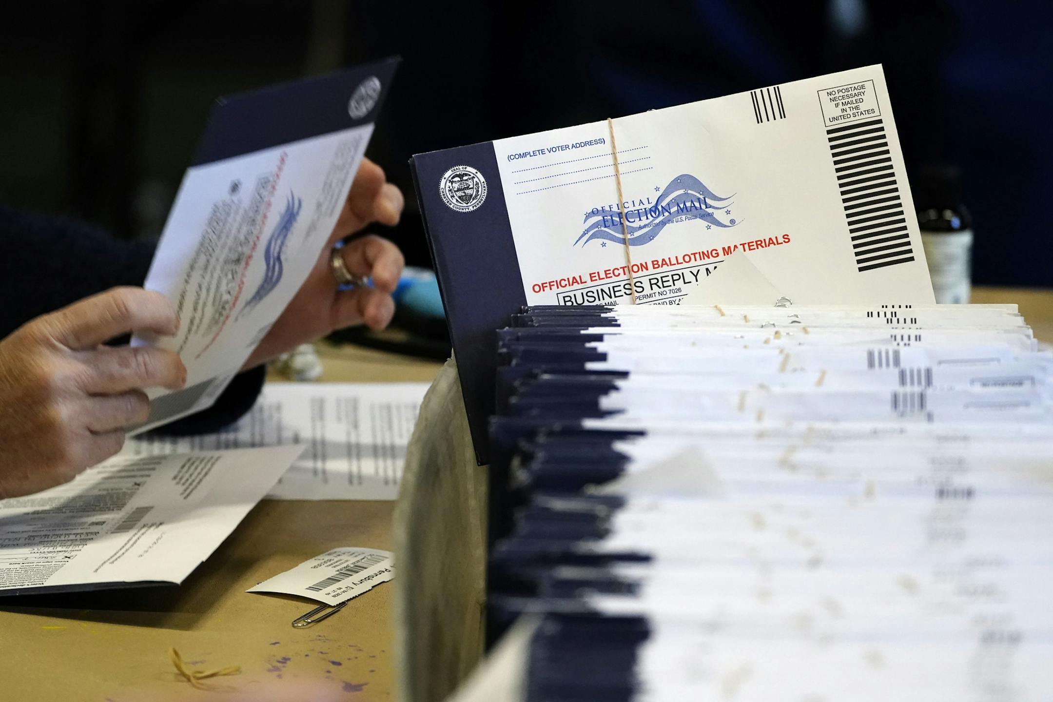 Chester County, Pa. election workers process mail-in and absentee ballots at West Chester University, Wednesday, Nov. 4, 2020, in West Chester. The fate of the United States presidency hung in the balance Wednesday morning, as President Donald Trump and Democratic challenger Joe Biden battled for three familiar battleground states, Wisconsin, Michigan and Pennsylvania, that could prove crucial in determining who wins the White House. (AP Photo/Matt Slocum)