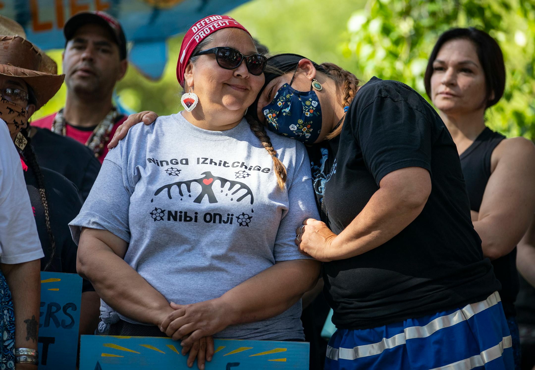 Nancy Beaulieu rested her shoulder on Everlasting Wind aka Dawn Goodwin during an interfaith prayer circle at LaSalle Lake State Recreation Area on Monday morning. The two women are self-described "tribal sisters" and co-founders of RISE Coalition.