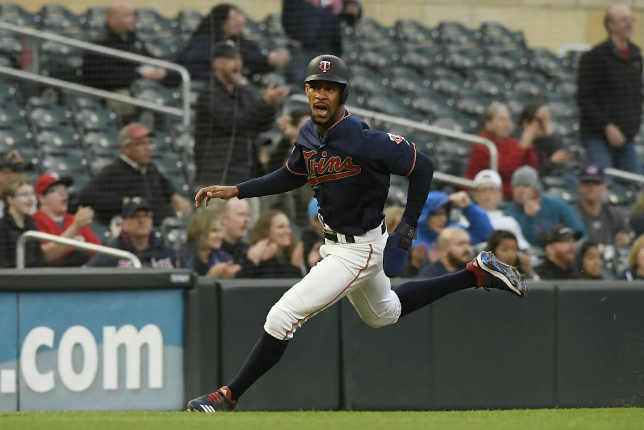 Minnesota Twins center fielder Byron Buxton (25) rounded the bases on his way to score a run off a triple hit by catcher Mitch Garver (18) in the bottom of the third inning against the Detroit Tigers.